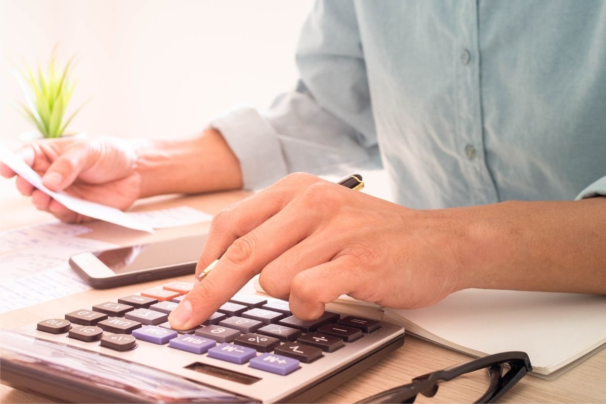 The image shows a man's hand reversing a budget.