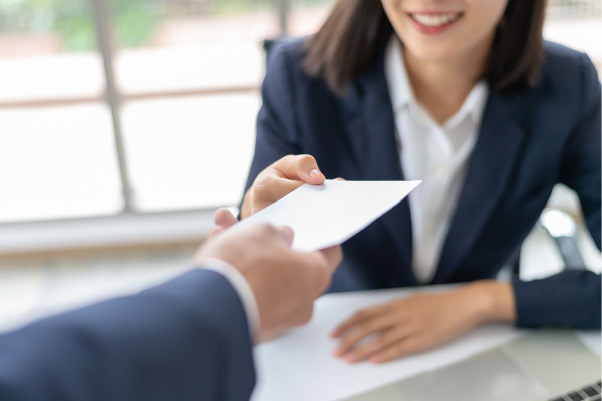 The photo shows an employee receiving estimated salaries.