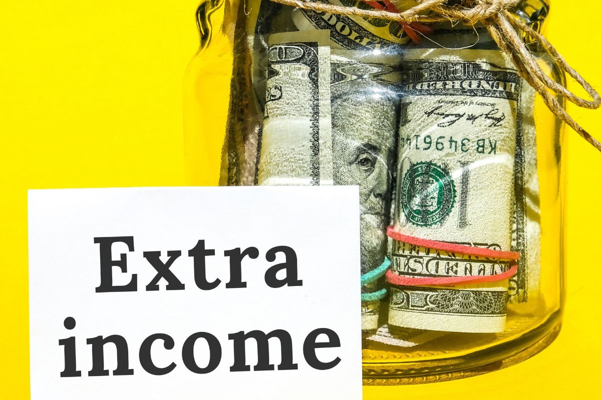The photo shows a jar with dollar bills and a paper with extra income.