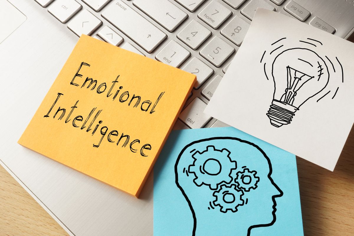 The picture shows papers with icons and emotional intelligence wording.