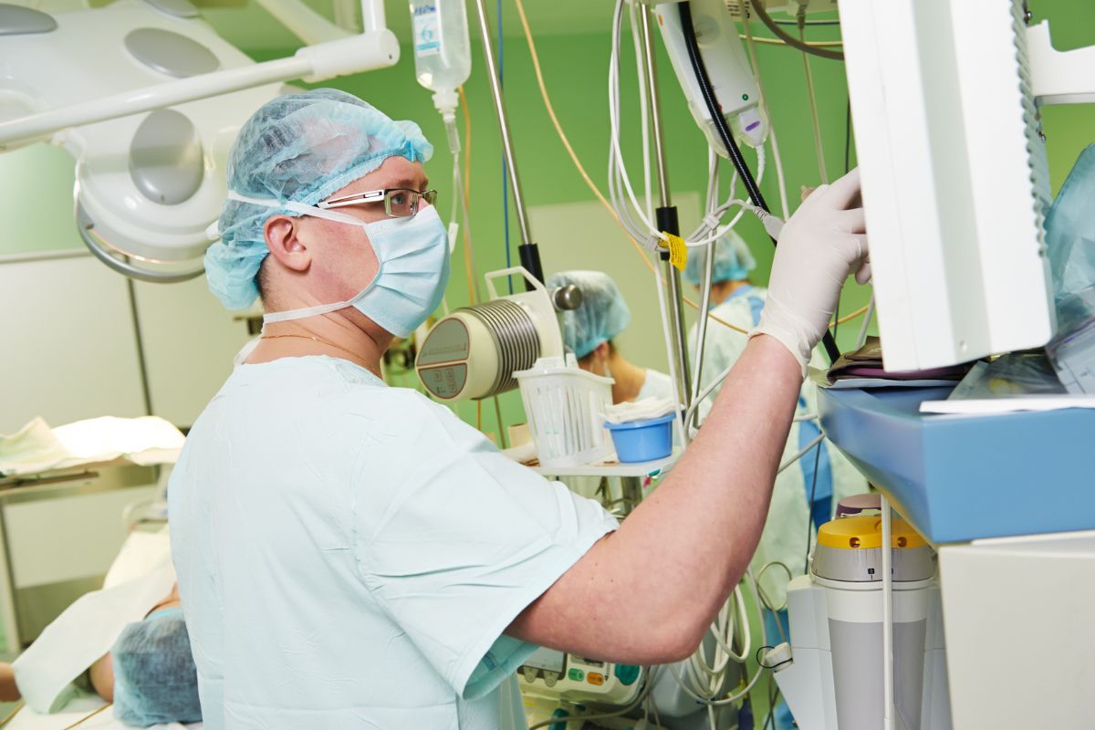 The photo shows a man working as an anesthesiologist.