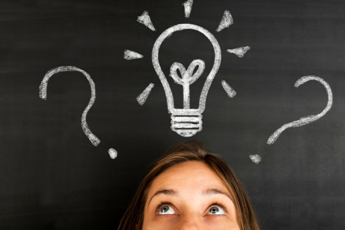 The photo shows a board with a bulb icon and question marks, and a girl looking upward referring to critical thinking helps avoid bad decisions and spot opportunities others miss.