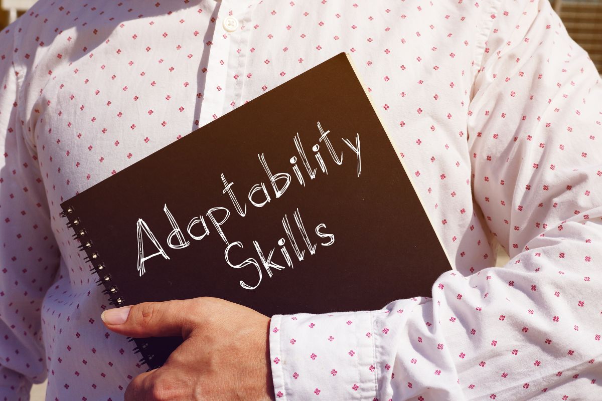 The picture of a man's hand holding a notebook with notes means learning adaptability helps with rejection, failure, and unexpected challenges.