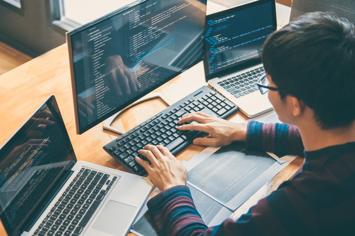 The image is about a man coding.