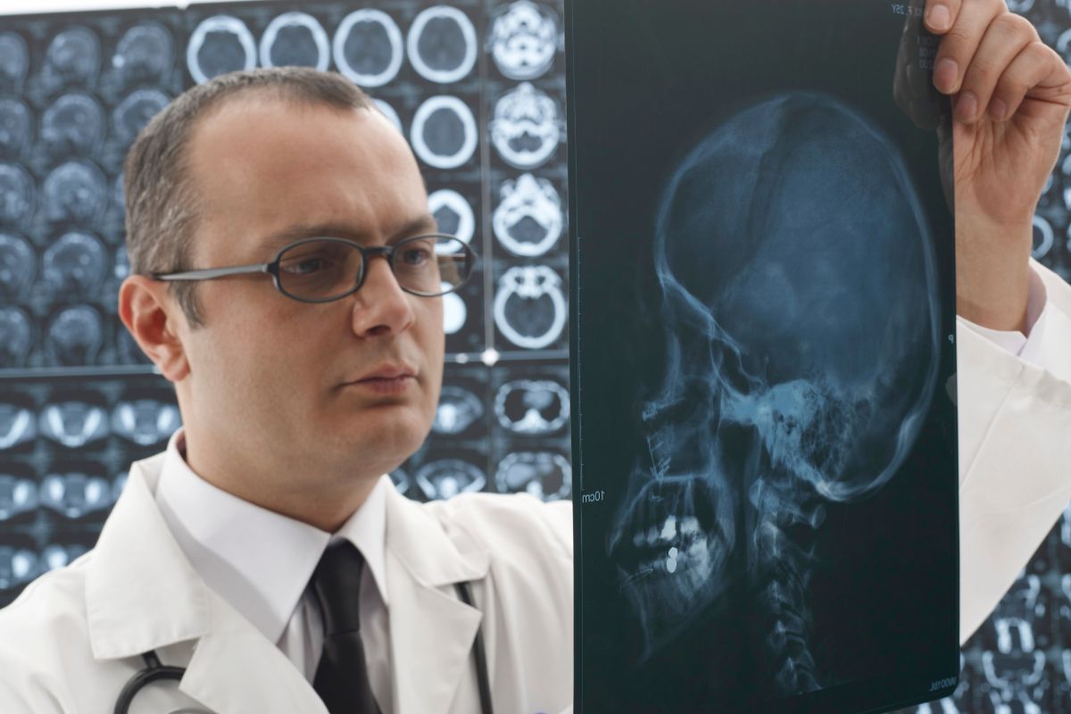 The photo shows a doctor looking at the head X-ray result which means neurosurgeon is one of the most respected and high-paying careers in medicine.