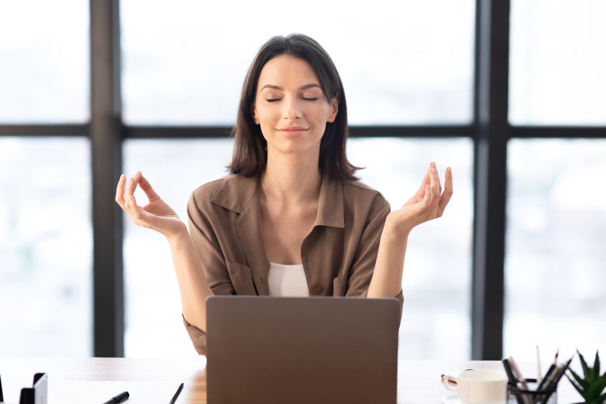 The picture shows a woman practicing stress management.