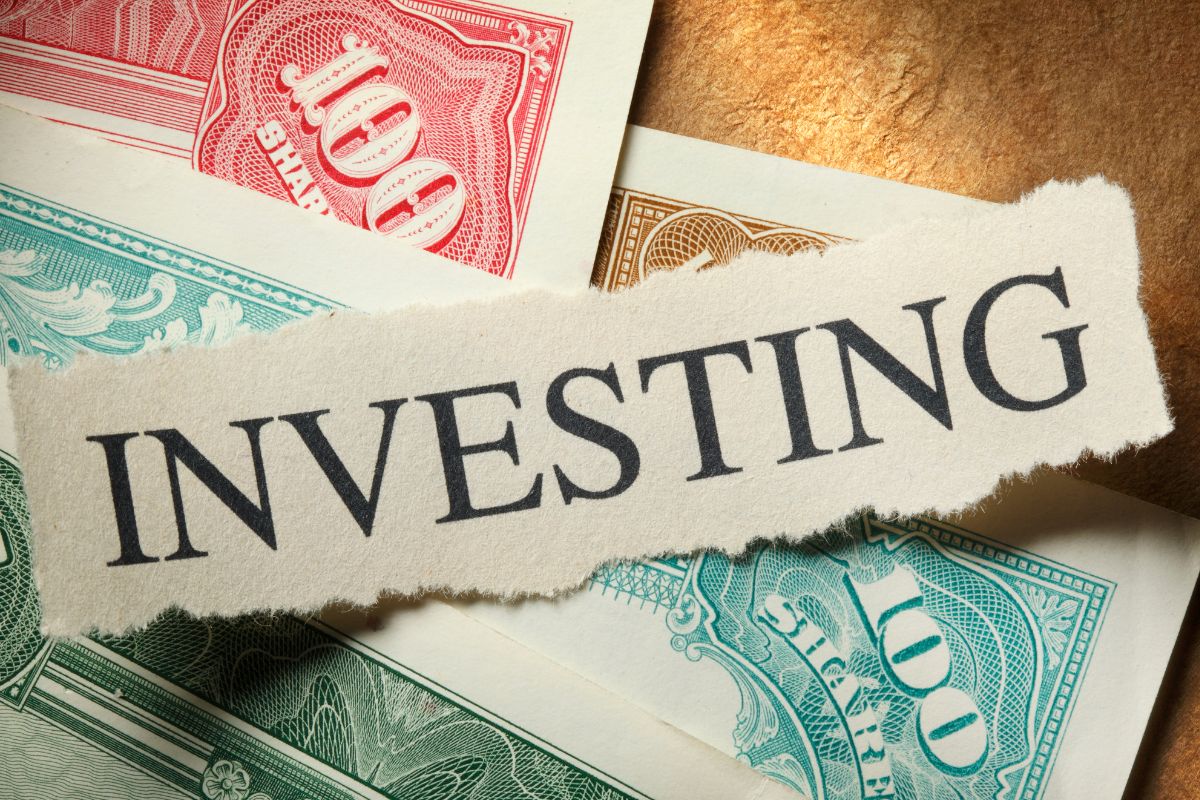 The picture shows a paper with investing word.