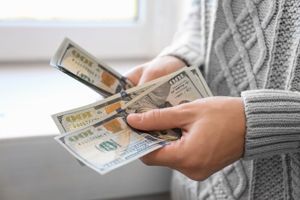 The image shows a girl's hand using a laptop and a visual search icon on the screen indicating to focus on these high-income skills early that bring real value in the workplace and make you stand out in the future.
