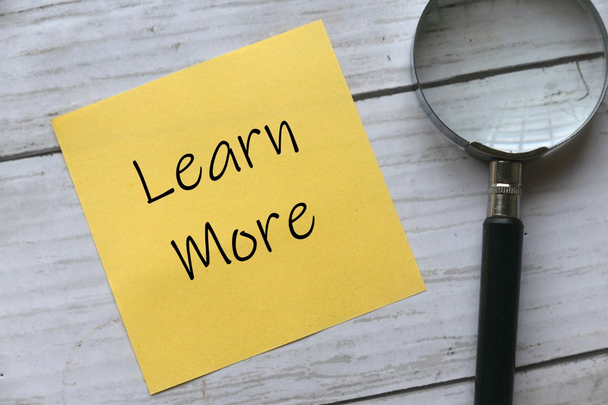 The picture shows a magnifying glass and a piece of paper with notes referring to learning the best money-saving habits that can make a big difference later.