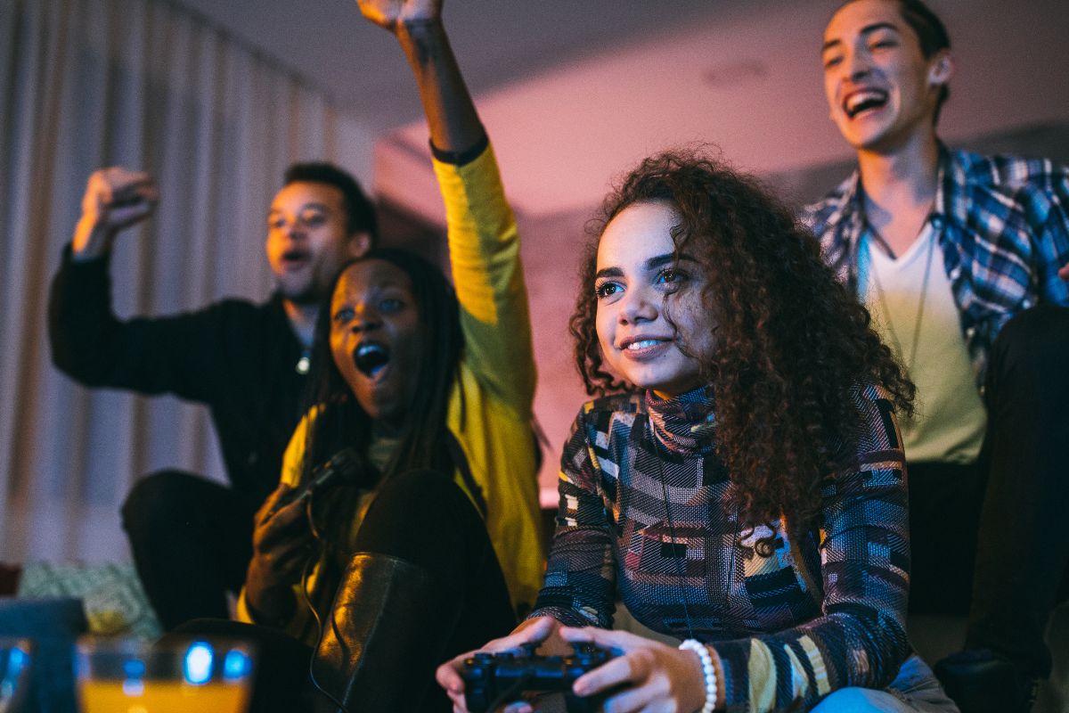 The image a group of young people playing video games.