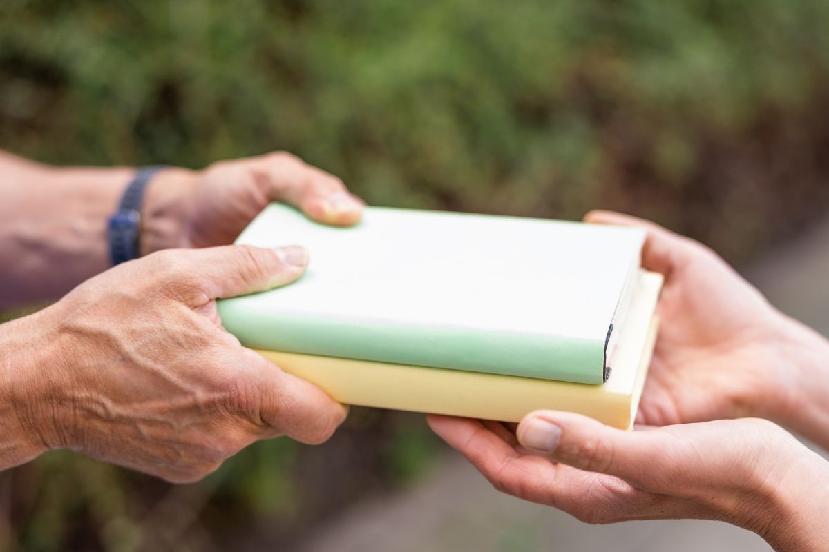 The photo shows people exchanging books. 