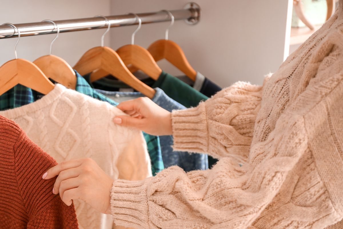 A women choosing clothes from her wardrobe.
