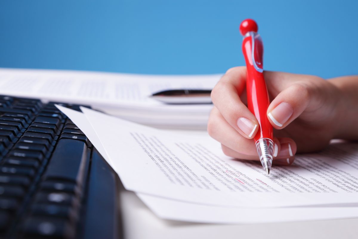The picture shows a lady proofreading.