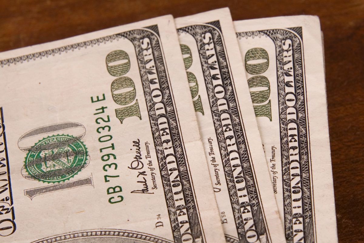 The image shows three hundred dollars.