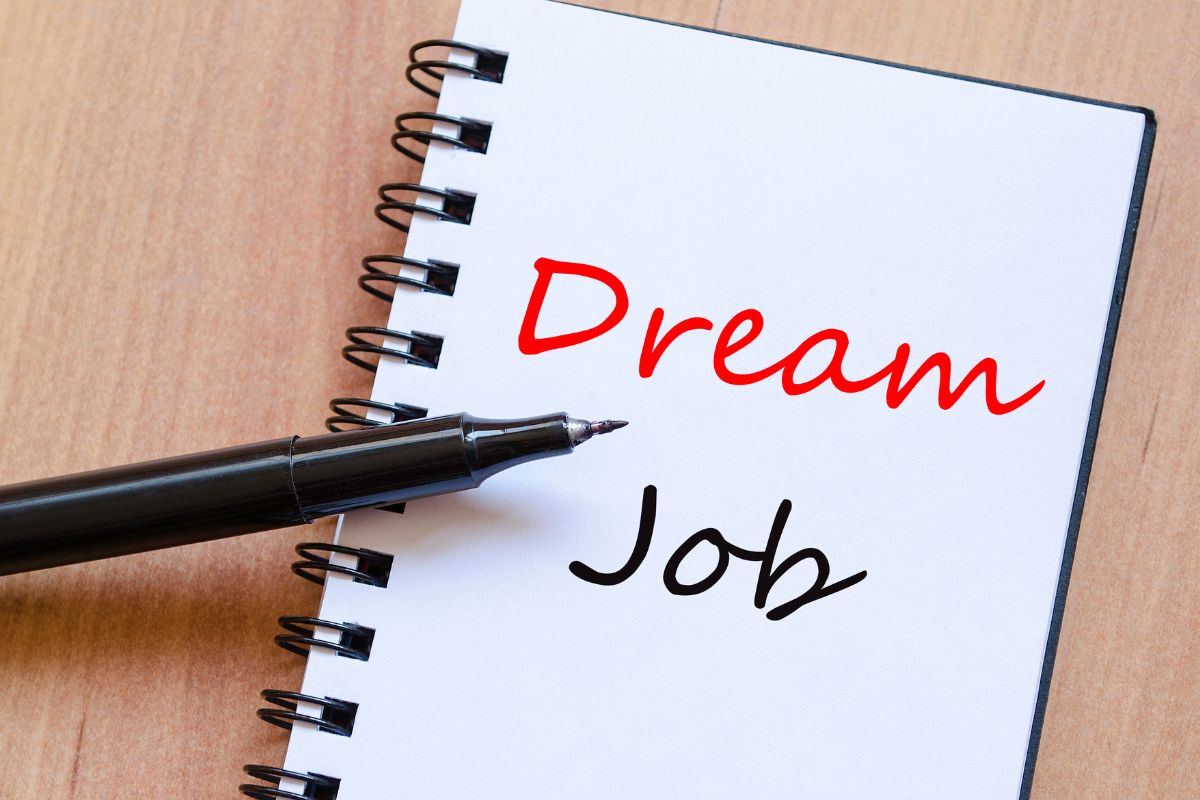 The image shows a pen and a notebook with a dream job.