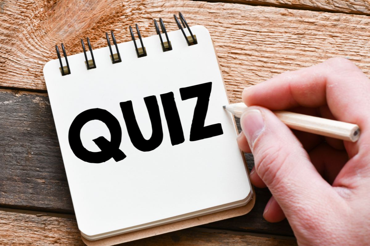 The image tells about a man's hand and writing on the mini-notebook which refers to taking this financially sound quiz helps you see the truth so you can make better choices.