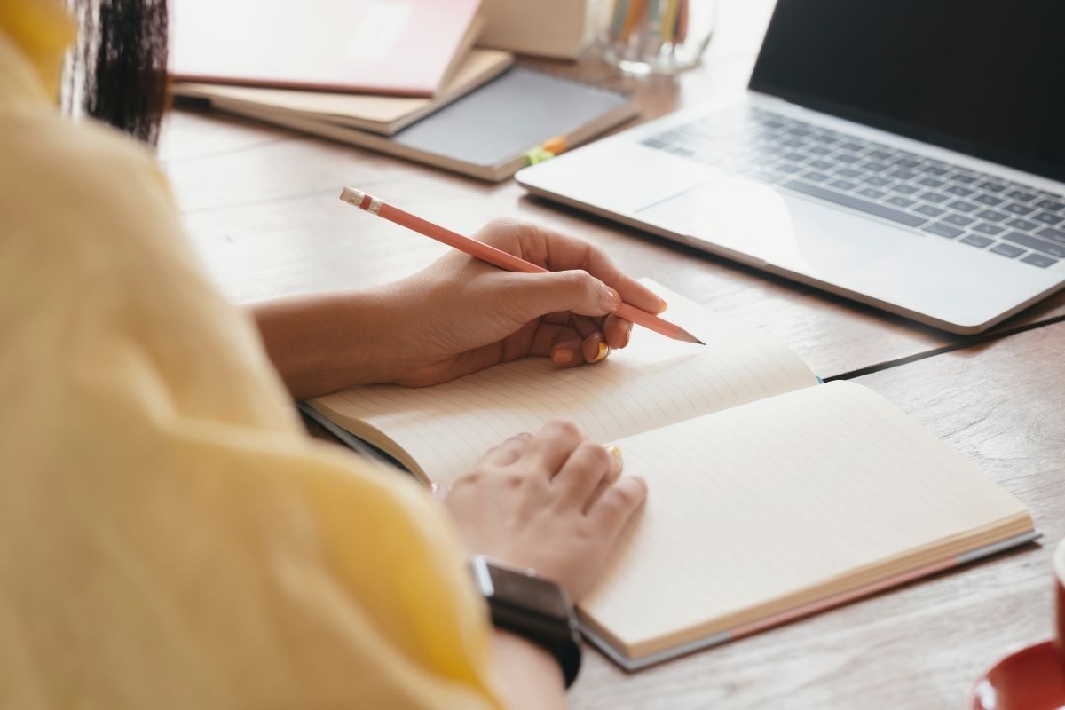 The photo shows a man's hand learning financial freedom.