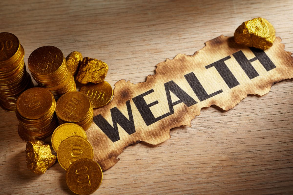 The picture tells about coins and a piece of paper with a note indicating to figure out if building generational wealth matters which can create lasting security for your family.