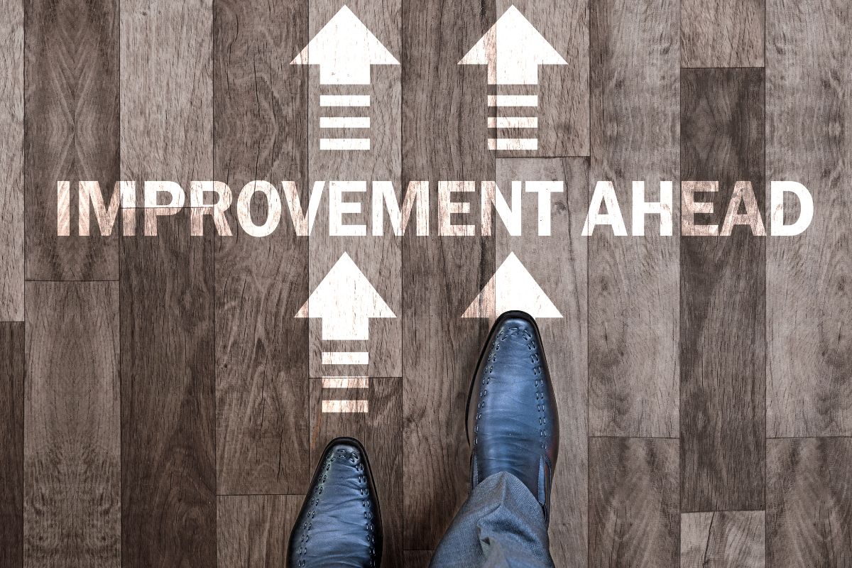 A man's foot and the improvement ahead wording.