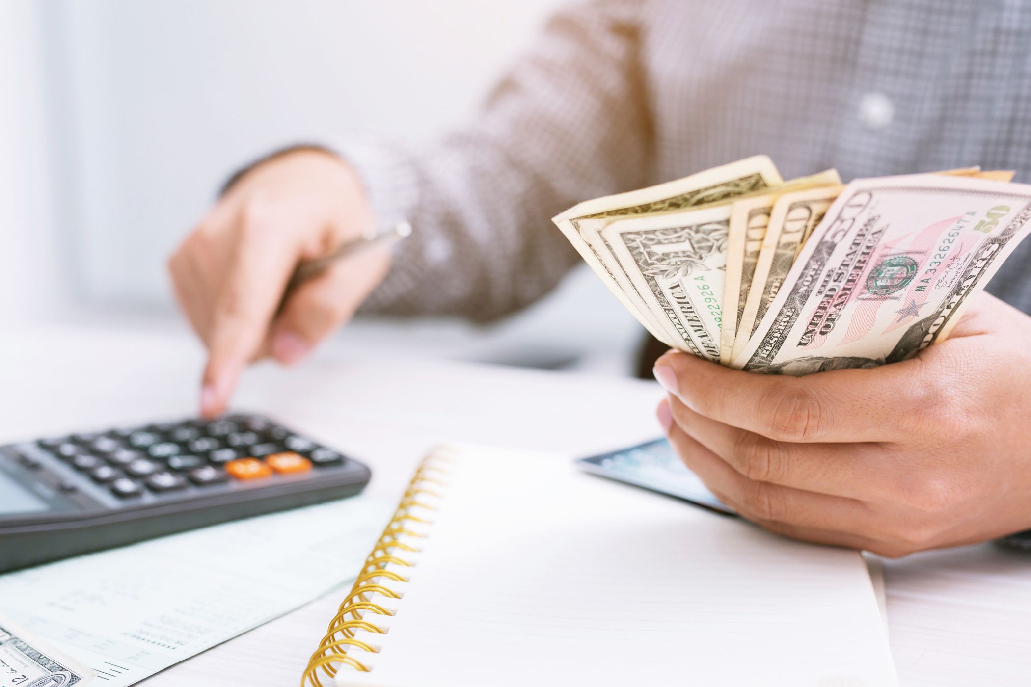 The image is about a woman's hand setting financial goals.