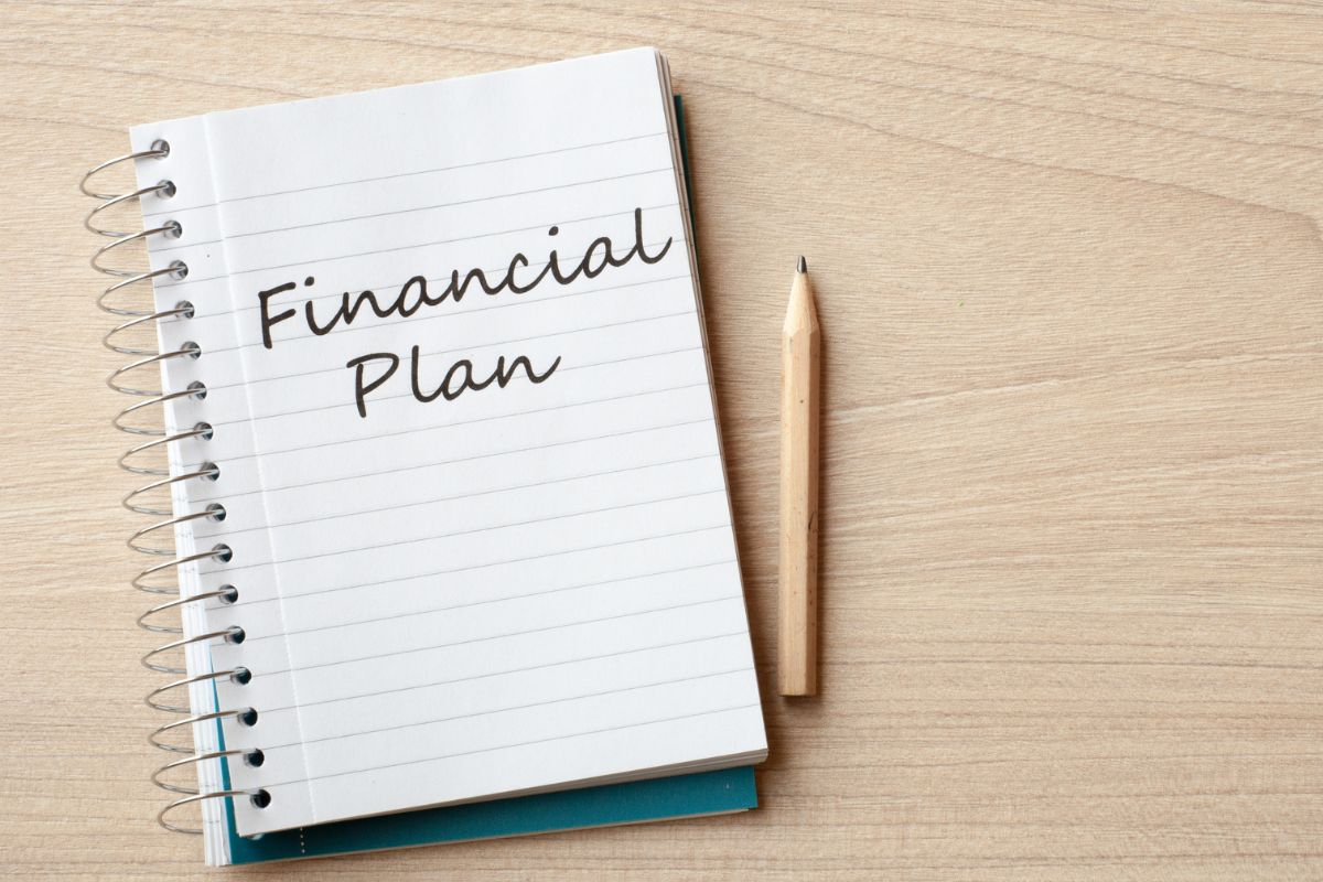 The image shows a pen and a notebook with notes that refer to the key components of a financial plan that help your money grow over time and keep you financially secure.