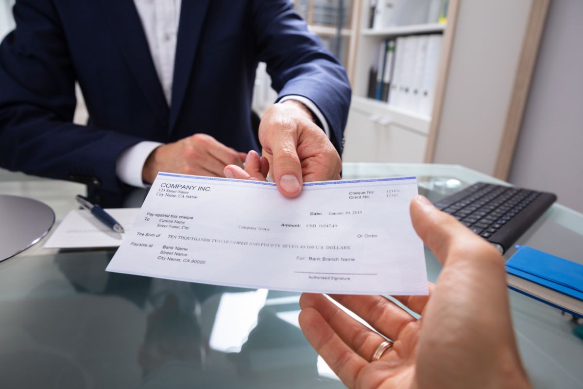 The photo shows a man living paycheck to paycheck.