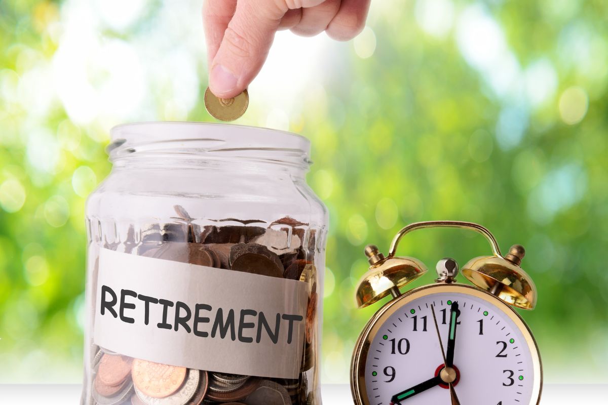 The picture shows a man's hand saving for retirement.