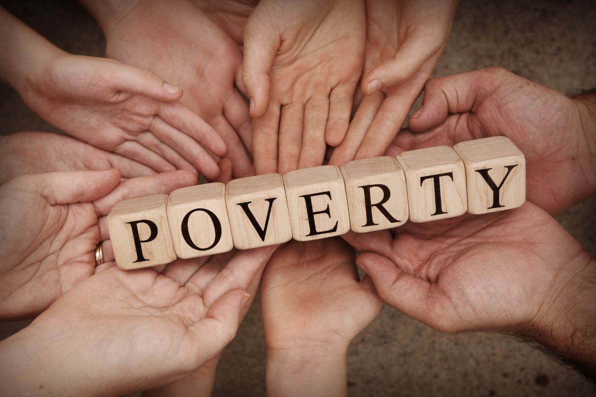The image is about a group of hands with poverty wording.