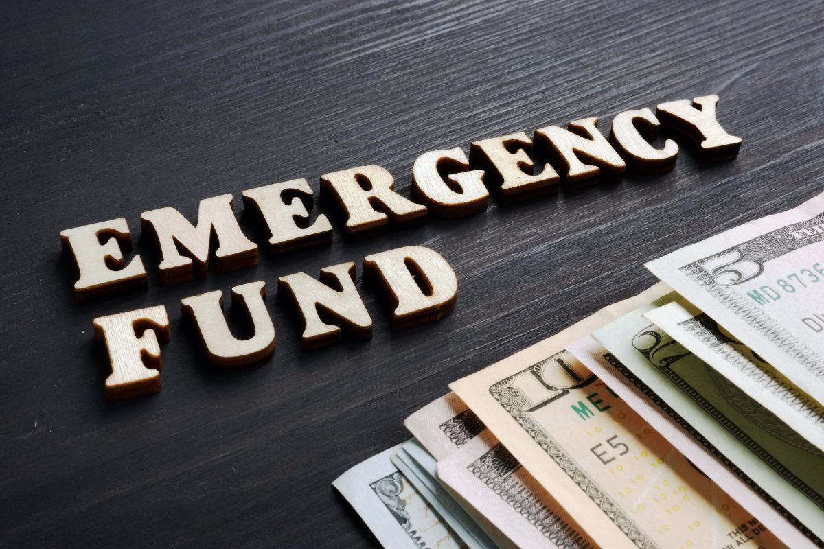The image is about dollar bills and emergency fund wording.
