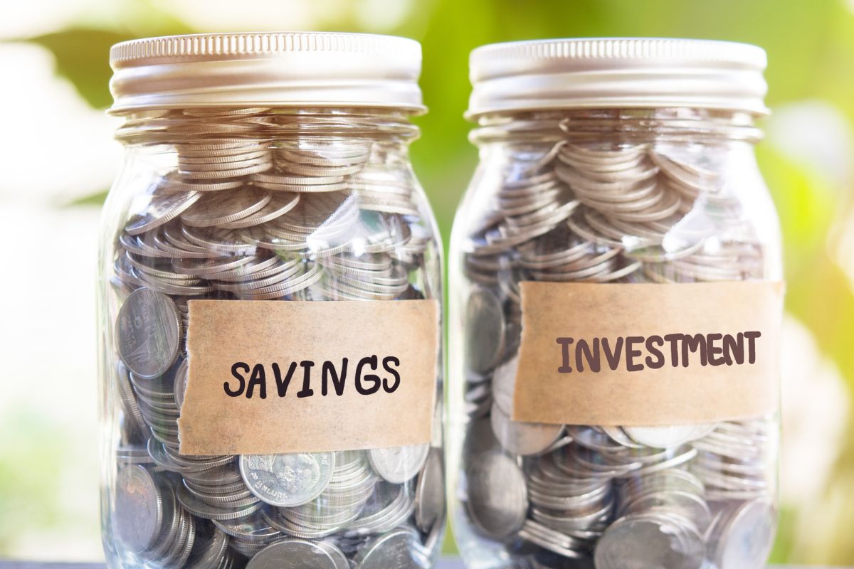 The photo shows jars with savings and investment wording.