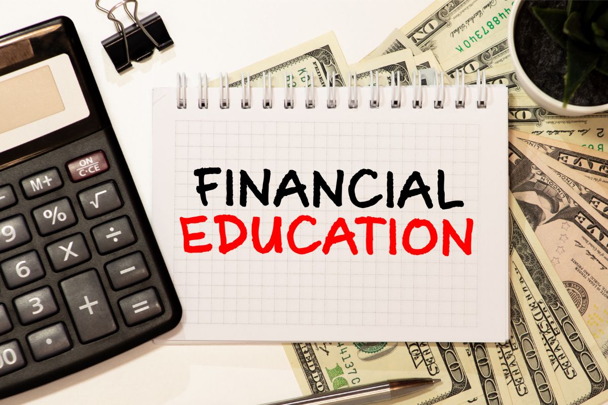 The picture shows a notebook with financial education wording.