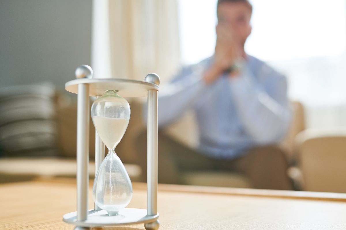 The photo shows a man waiting for the glass hour.