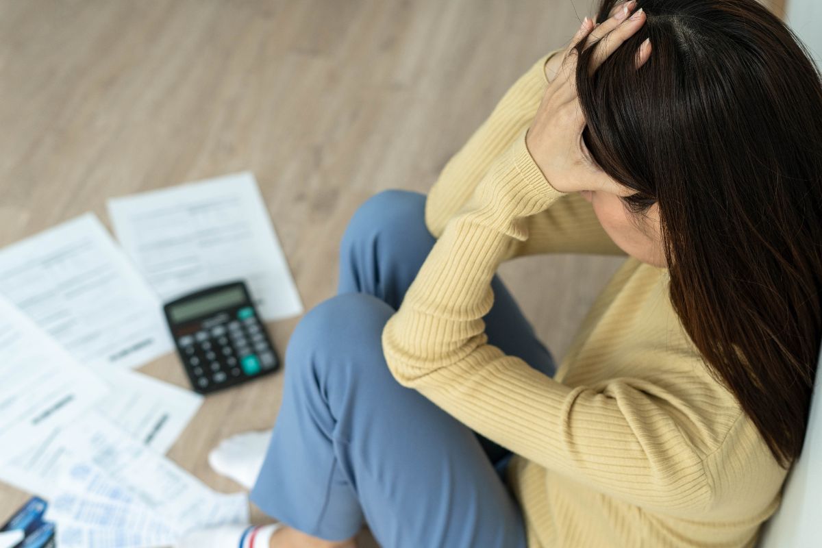 The image shows a woman with financial mistakes.