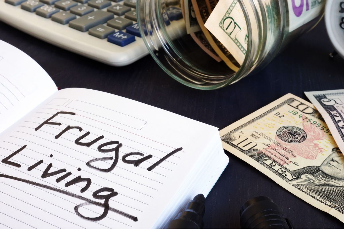 The photo shows dollar bills and a notebook with frugal living wording.