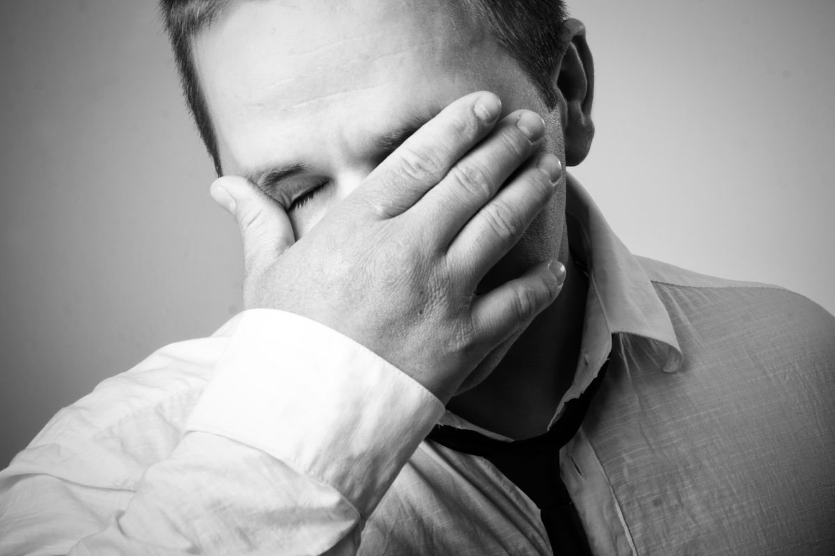The picture shows a frustrated man indicating that turning past financial regrets into actionable checklists gives you control instead of guilt.