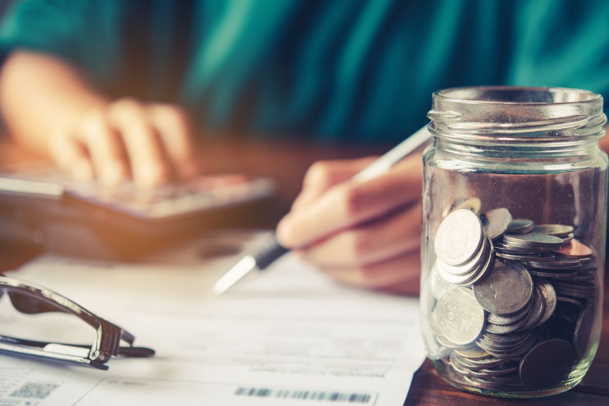 The image shows a woman assessing her financial situation.