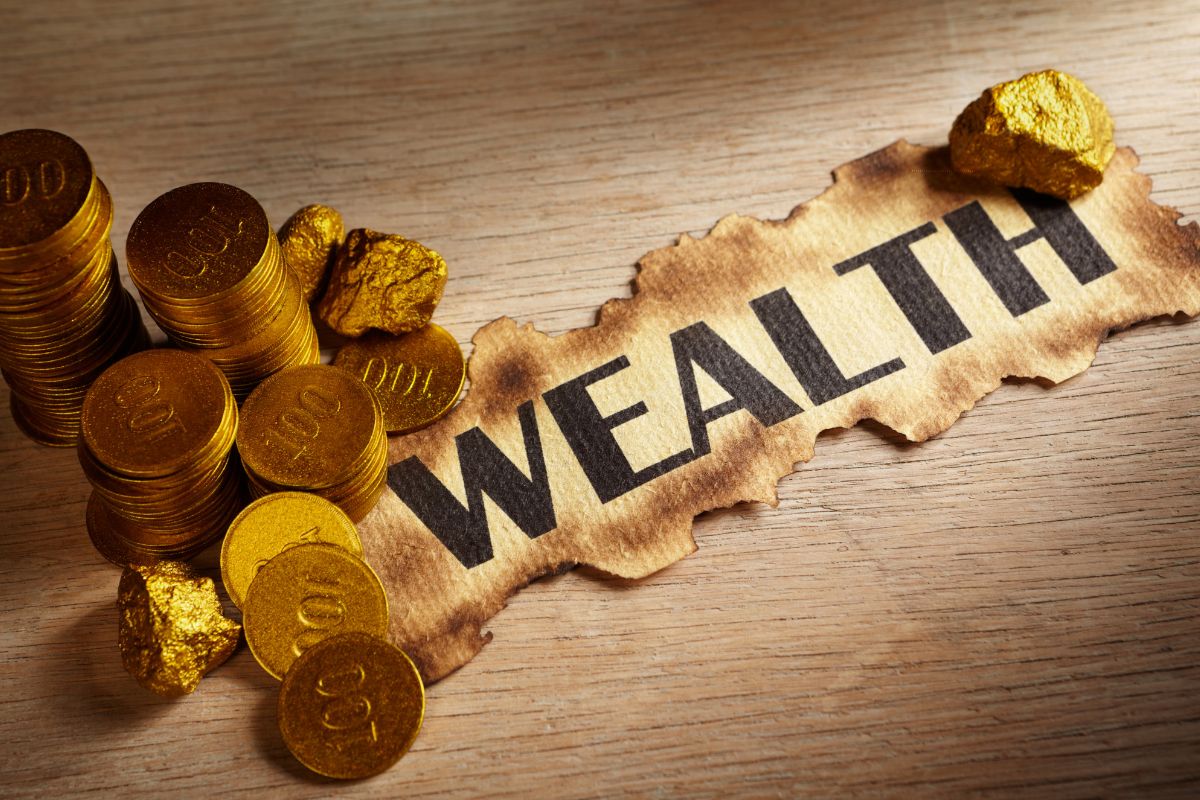 The picture shows coins and wealth wording.