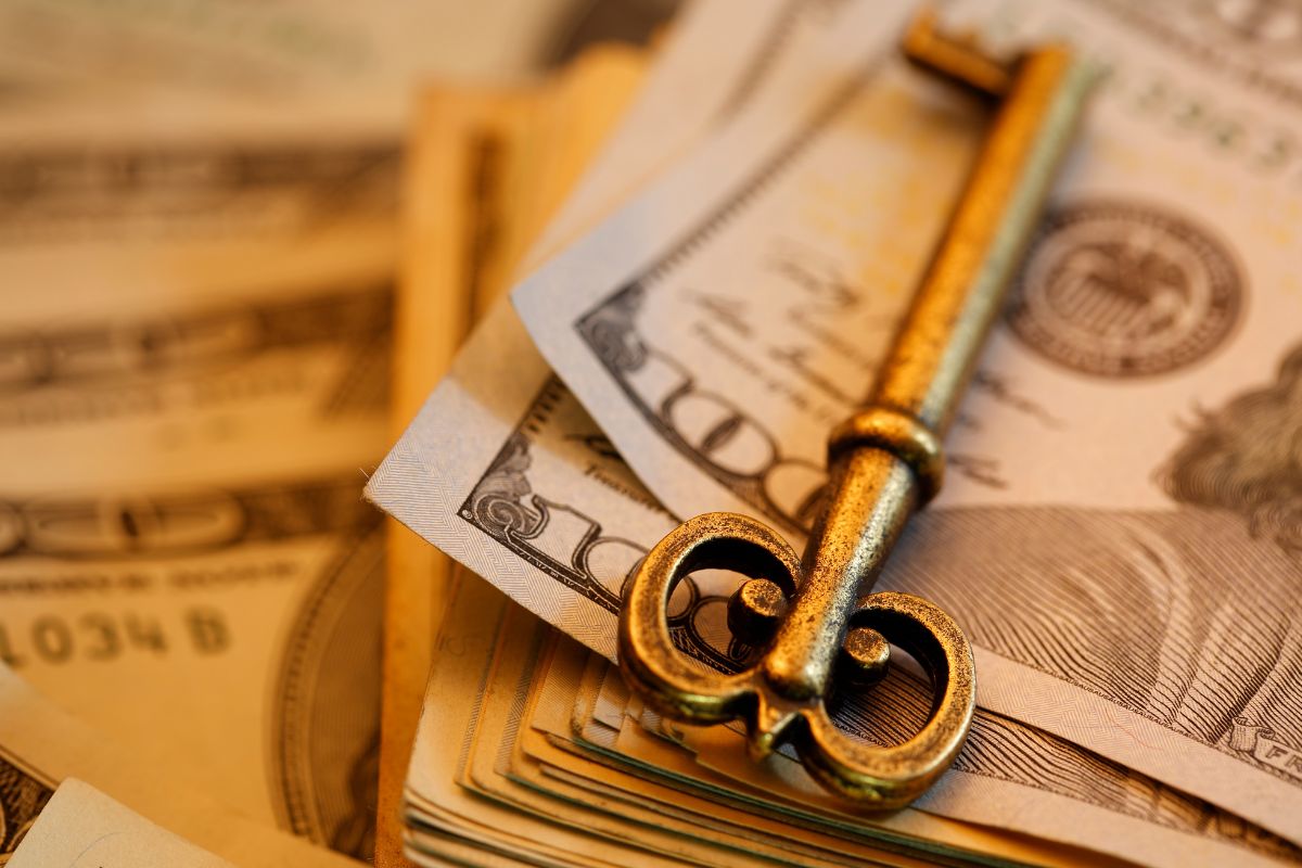 The image shows dollar bills and a key.