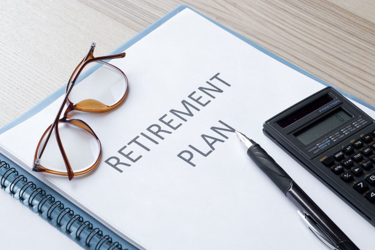 The image shows a notebook with retirement plan wording.