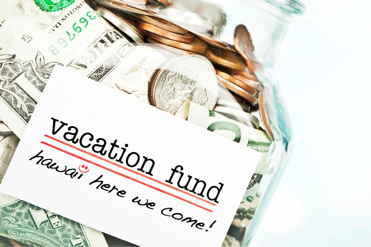 The photo shows a jar with cash for the vacation budget.