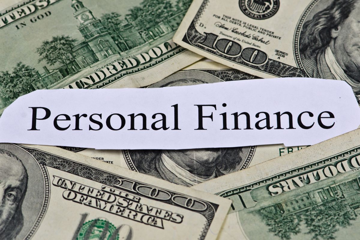The picture shows dollar bills and paper with personal finance wording.
