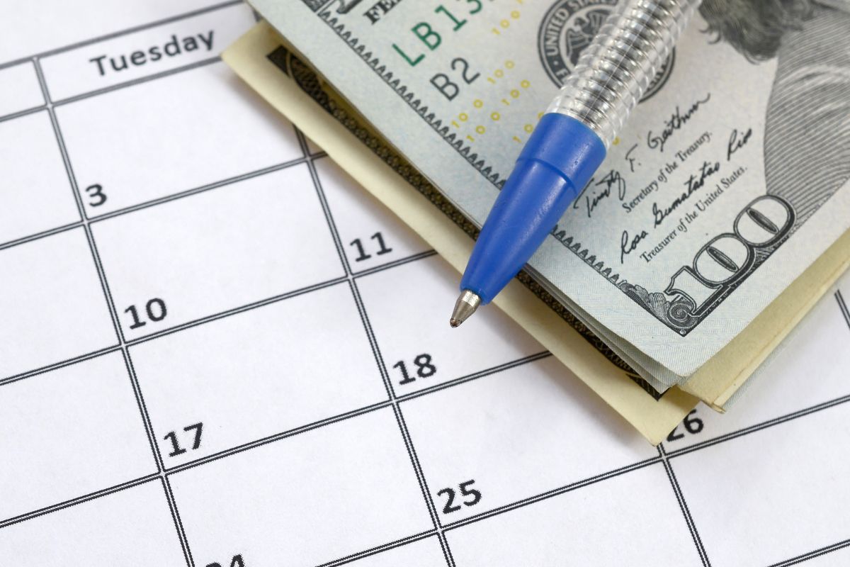 The image of dollar bills and a calendar.