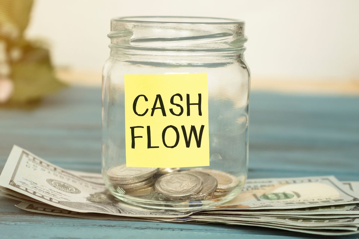 The photo shows dollar bills and cash flow wording.