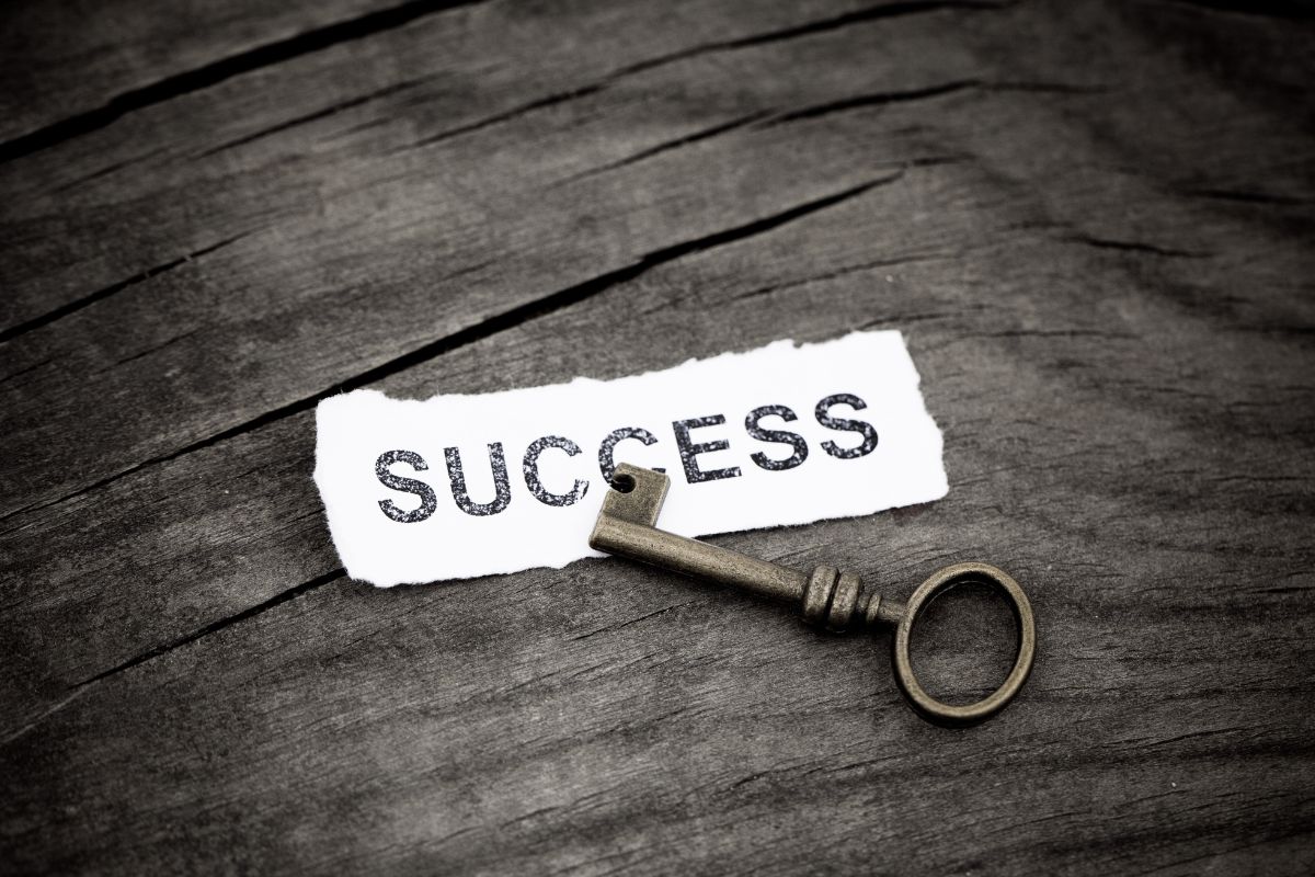 The picture is about a key and paper with success wording.