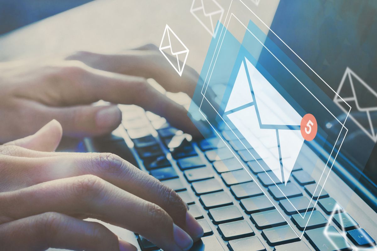 The picture shows a man's hand using laptop or mailing.