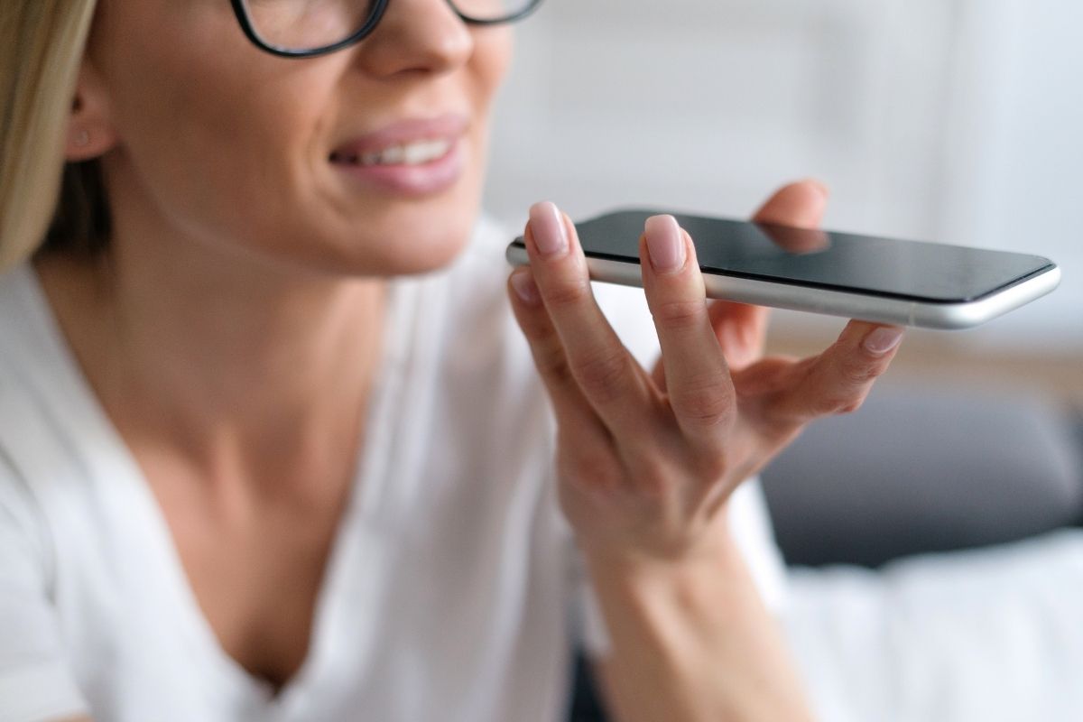 The picture shows a woman recording voice memos.
