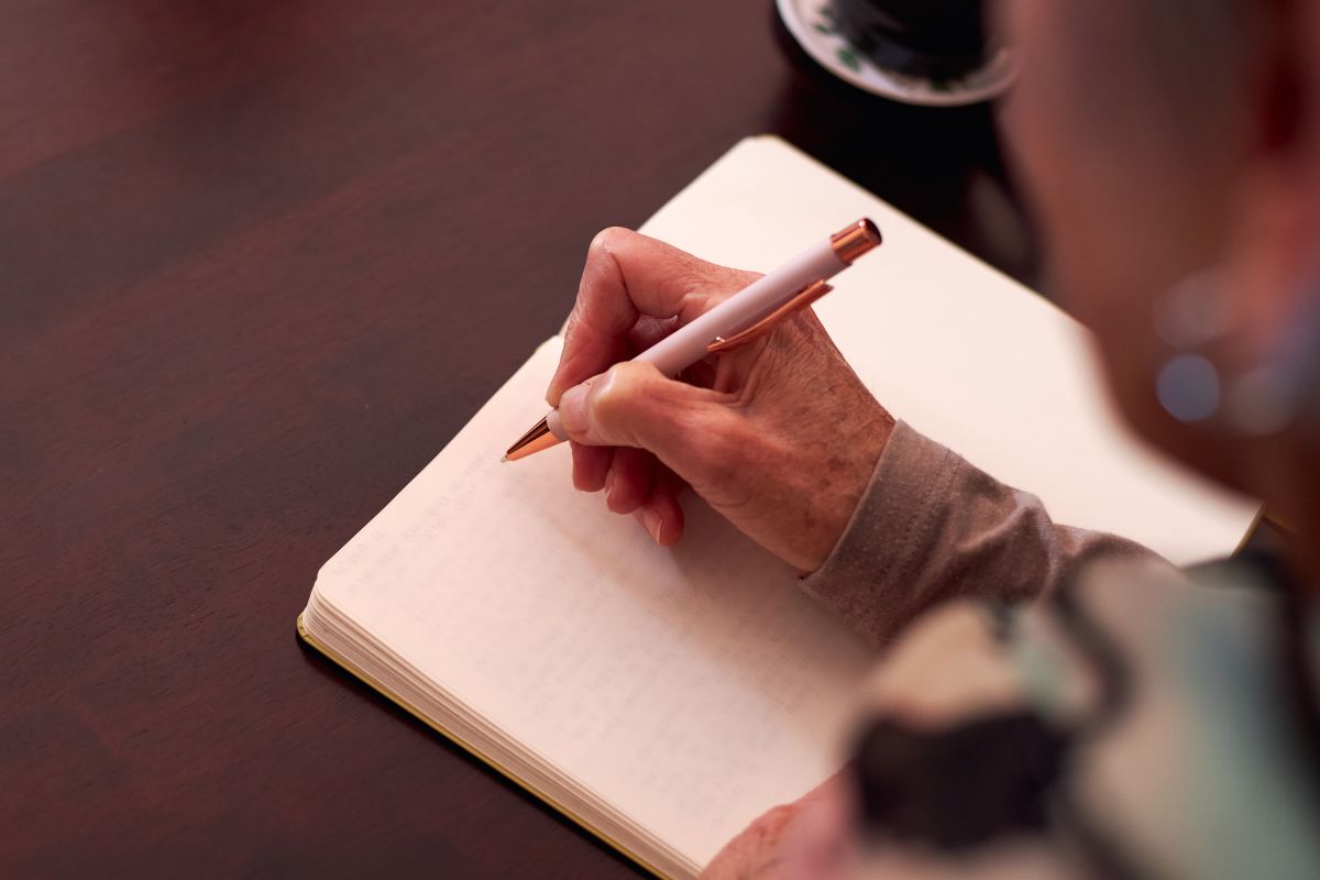 The photo is about a woman writing a breakup letter about debt.