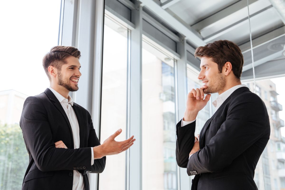 The photo shows men talking to allies.