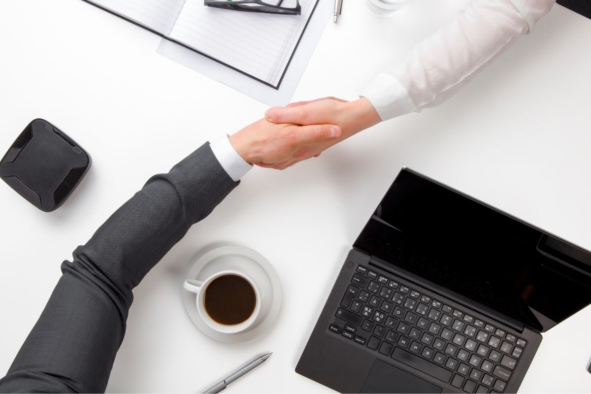 The image shows two hands offering a trade.