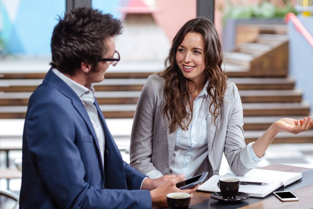 The photo shows two people talking.